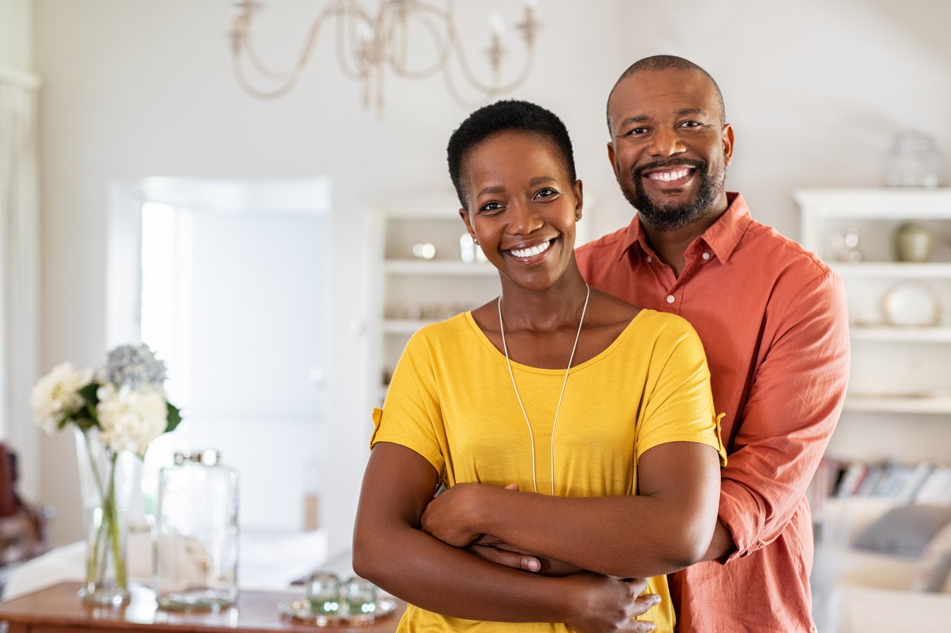 a couple posing for a photo in their living room